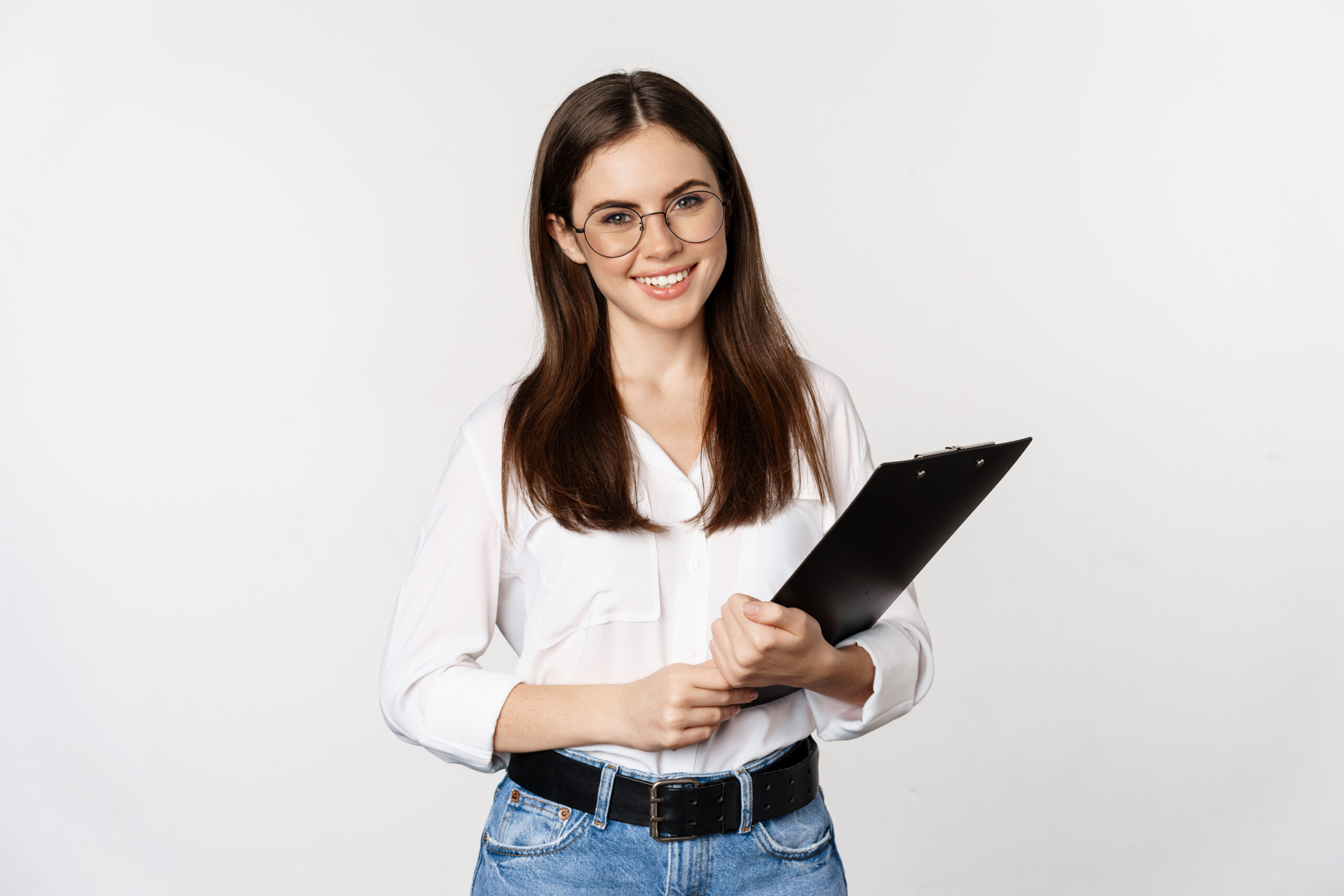 Portrait of corporate woman holding clipboard at work, standing in formal outfit over white background.